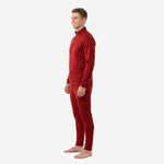 Custom red soccer tracksuit opposite side angle showing stand collar full-zip jacket and tapered crimson pants on male model