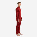 Custom red soccer tracksuit side view showing chevron jacquard texture on crimson jacket and tapered pants on male model