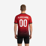 Close detail of halftone dot-burst gradient on custom red soccer training jersey transitioning from Crimson Red to Jet Black