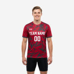 Custom red soccer training jersey in Crimson and Charcoal geometric print with team name and number on front, worn by adult male model