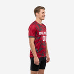 Custom red soccer training jersey side view showing Charcoal triangle geometric pattern across Crimson base fabric