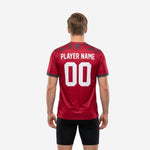 Red soccer training jersey with white team name and squad number printed on Crimson and Charcoal geometric sublimated fabric