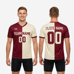 Full-body view of an adult male wearing a custom red soccer training jersey in maroon and cream with athletic cut and sublimated print