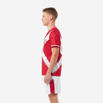 Custom red soccer uniform side view showing full-dye sublimation print on red jersey with white contrast trim at crew neckline and cuffs
