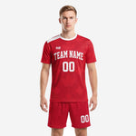 Custom red soccer uniform front view showing geometric star jersey and matching red shorts with white contrast panels on adult male model