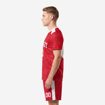 Custom red soccer uniform right side view showing sublimated geometric pattern and white trim detail on adult male model