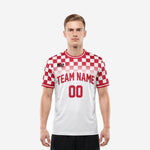 Custom red and white soccer jersey with checkerboard pattern on shoulders and sleeves, team name and number on chest, front view on male model