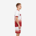 Custom red soccer uniform side view showing crimson-to-white gradient on jersey and matching shorts