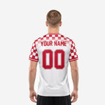 Red and white soccer jersey back panel showing player name arced above back number with checkerboard shoulder yoke detail