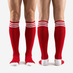 Custom red and white striped soccer socks for team orders with personalized name and number printing