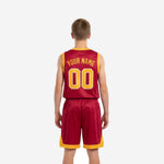 Side view of crimson red youth basketball uniform set showing gold armhole binding on sleeveless jersey and elastic waistband on matching shorts