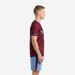 Side view of custom retro soccer uniform showing maroon stamp-motif jersey with powder blue crew-neck trim and matching shorts