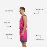 Custom reversible basketball uniform pink and charcoal shorts detail showing halftone dot fade, elastic waistband, and contrast hem band