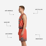Back view of orange side reversible basketball uniform showing teal back number and halftone dot pattern across lower jersey and shorts hem