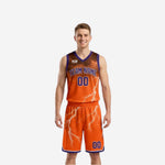 Orange side of custom reversible team basketball uniforms with purple trim and white lightning bolt graphic, front view on male model