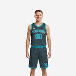 Custom reversible team basketball uniforms in teal and charcoal topographic pattern shown front view on male adult model with matching shorts