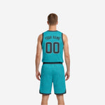 Side view of the custom teal and charcoal reversible basketball jersey showing V-neck binding and armhole edge detail
