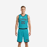 Teal side of the reversible basketball uniform set with charcoal trim, team name arc and front number on male adult model