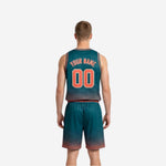 Side view of teal custom reversible basketball uniform showing V-neck binding, armhole trim, and shorts side panel construction