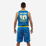 Opposite side view of royal blue and yellow basketball tournament uniform showing yellow side stripe on shorts leg and hex circuit print