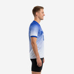 Side view of a custom royal blue gradient soccer training jersey showing short sleeve and Royal Blue cuff trim on adult male model