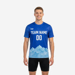 Custom royal blue practice jersey with ice blue mountain hem gradient and white team name, worn by adult male model, front view