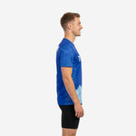 Mens custom royal blue practice jersey showing botanical leaf sleeve print and ice blue lower hem, left side view