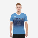 Men's custom royal blue soccer jersey with sky blue to navy blue dot-burst gradient and white V-neck trim, front view