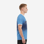 Custom royal blue soccer jersey with sublimated dot-burst gradient, left side profile view on adult male model