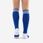 Custom royal blue soccer socks with white contrast stripe bands shown from the back on adult male model, over the calf length