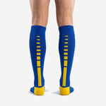 Custom royal blue soccer socks calf panel detail showing ribbed elastic cuff band and solid blue body