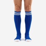 Close detail of the ribbed cuff on royal blue soccer socks with three white stripe bands for club team matchday wear