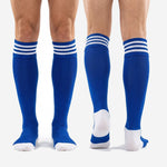 Custom royal blue soccer socks shown from front and back views with white heel and toe panels, three white stripe cuff bands