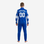 Royal blue soccer tracksuit jacket detail view with stand collar, full-zip front, and sublimated splash-fade white sleeve gradient