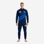 Custom royal blue soccer tracksuit in navy and royal blue diagonal panel design, front view on adult male model
