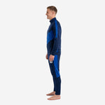 Men's custom royal blue soccer tracksuit right side view showing diagonal contrast panel geometry on jacket and pants