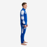 Royal blue soccer tracksuit left side view displaying white dot-burst gradient sleeve and side panel stripe on tapered pants