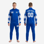 Blue and white soccer tracksuit sleeve close-up showing full-dye sublimation splash-fade gradient from cuff to shoulder