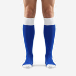 Custom royal blue soccer socks with white ribbed cuff and white toe cap, front view on adult male model