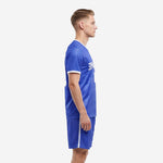 Custom blue and white soccer uniforms side view showing Royal Blue jersey with white cuff trim and matching shorts on adult male model