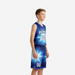 Side view of royal blue and white youth basketball uniform set showing starburst sublimation pattern on jersey and shorts