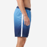 Custom navy blue gradient soccer shorts showing white sublimated side stripe along left leg seam, side view on adult male model