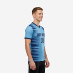 Mens custom training jersey sky blue and navy blue sublimated streak pattern, left side view showing sleeve cuff and side print coverage