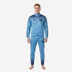 Custom sky blue and navy blue soccer tracksuit full front view showing dot-burst gradient print and team logo placement on adult male model