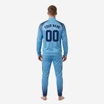 Custom sky blue navy soccer tracksuit jacket detail showing dot-burst sublimation print on shoulders and ribbed cuffs