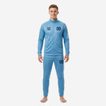 Custom sky blue soccer tracksuit front view showing navy team logo and number on chest and thigh