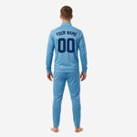Sky blue soccer tracksuit jacket detail showing stand collar full zip and raglan sleeves with ribbed cuffs