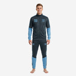 Custom sky blue soccer tracksuit in Steel Blue and Sky Blue colorblock worn by adult male model, front view showing chest number and team logo print zones