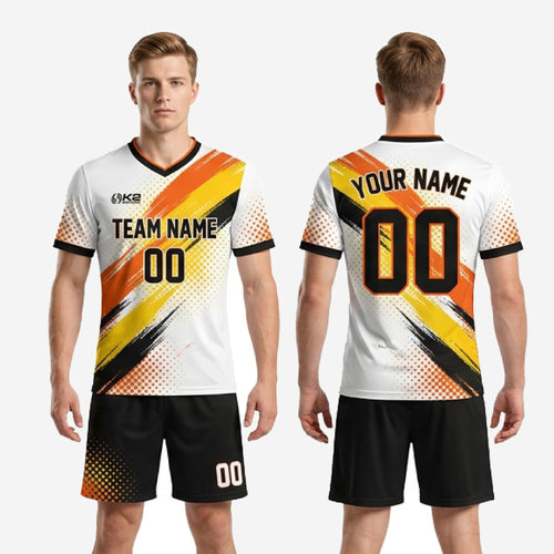 Custom black soccer shorts with orange and yellow halftone dot burst print at hem, part of white and orange men's soccer uniforms for teams package