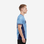 Custom soccer team shirts powder blue body with navy contrast side panels and white piping, side view left